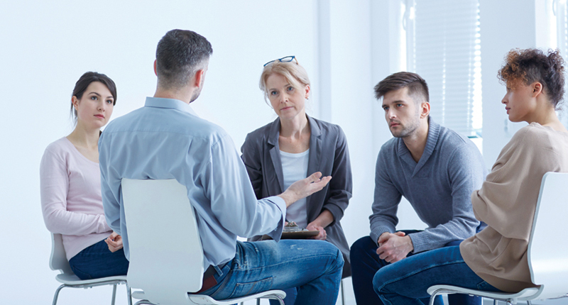 People participating in group therapy for PTSD